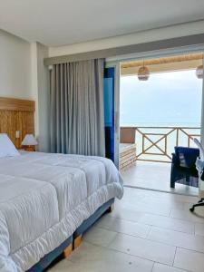 托卢Suite, Eco Hotel Laguna Beach的一间带大床的卧室和一个阳台