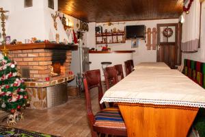 班斯科Къща за гости Даутев Връх的一间设有壁炉、桌子和圣诞树的客房