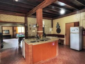帕罗卡Tô na Guarda Hostel的厨房配有水槽和冰箱