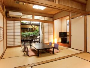 佐贺市Oyado Yumechidori的一间带桌椅的房间和一间用餐室