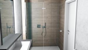 瓦伦莱斯克乐瓦伦酒店的浴室里设有玻璃门淋浴