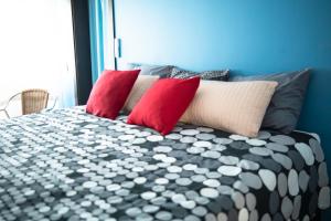 法鲁Beach Apartment的一张带红色和白色枕头的床
