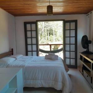 卢米亚Pousada Som de Lumiar的一间卧室设有一张床和一个大窗户