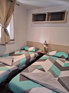鲁西隆地区卡内Mobile home Chic的带窗户的客房内设有两张单人床。