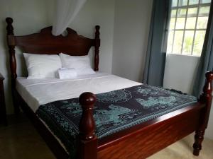 罗索科罗索尔公寓酒店的一张带木制床头板和白色床单及枕头的床