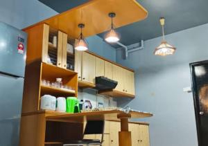波德申2BR Apartment in Port Dickson Bayu Beach Resort的厨房配有木制橱柜和2盏灯