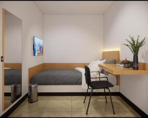 三宝垄Check Inn Permata Hijau的一间卧室配有一张床和一张桌子及椅子