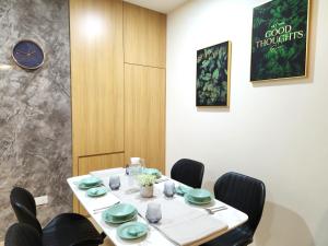 古晋Kuching City Centre Smart Home Luxury Resort Condo的一间带桌椅和时钟的用餐室