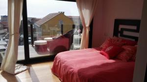 Teiraduplex de lujo en medio del paraiso的一间卧室设有红色的床和大窗户