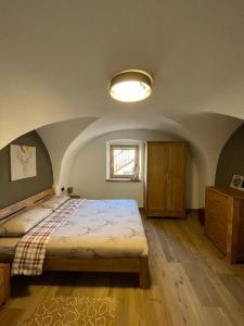 卡拉诺Appartamento Gioia di Bosco的一间卧室设有一张大床和一个窗户。