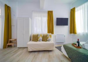 马德里(J1) Ubicado en Madrid Centro - 5 personas.的客厅配有白色沙发和黄色窗帘