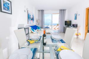 库姆布勒德尔索尔Panoramic Apartment的一间设有玻璃桌和白色椅子的用餐室