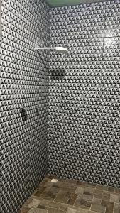 里约布兰科Condomínio luiza的浴室铺有灰色和白色瓷砖,设有淋浴。