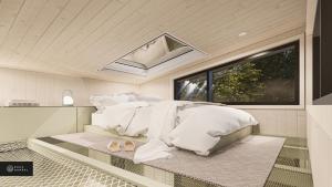 BuryMiniBora Le lichen - Cantons-de-l'Est的一间卧室配有一张带白色床单的床和一扇窗户。