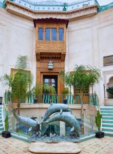 马拉喀什Sillage Palace Sky & Spa的一座建筑前的海豚雕像