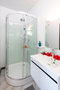 波拉波拉Matira Beach Raitea 1的带淋浴和盥洗盆的白色浴室