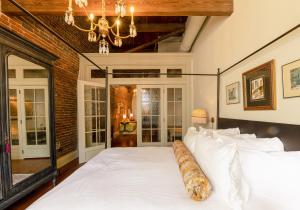 诺克斯维尔Hotel Cleo Knoxville的卧室配有一张带吊灯的大型白色床。