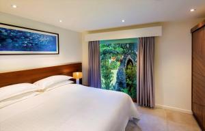 托阔里奇斐济托阔里奇岛喜来登水疗度假酒店的一间卧室设有一张床和一个大窗户
