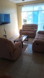 蒙巴萨Nyali cozy home的客厅配有两张沙发和一张咖啡桌