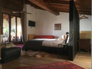PonteranicaB&B con SPA il Castello di Lucawest的卧室配有一张床,地板上放着一只狗