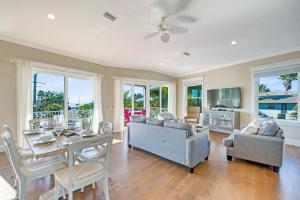 布雷登顿海滩Tropical Hideaway的客厅配有桌子、沙发和椅子