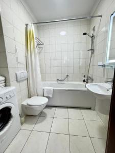 敖德萨阿卡达公寓酒店的带浴缸、卫生间和盥洗盆的浴室