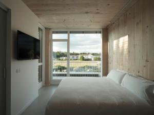 欧德鲁佐Hotel Amiuka的卧室设有白色的床和大窗户