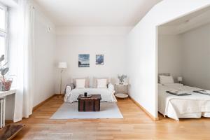 赫尔辛基Cozy, spacious and calm city home - top location的白色的客房配有两张床和镜子
