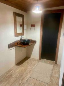 阿尤鲁奥卡Casa Portal Sagrado Matutu- Aiuruoca MG的一间带水槽、镜子和门的浴室