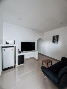 苏梅岛L.C. Apartments的白色的客厅配有电视和沙发