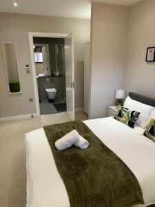 伦敦Richardson Deluxe Apartments (2-Bed)的一间卧室配有一张大床,上面有毛巾