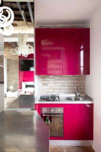 罗马Monti apartment BDB的一间带红色橱柜和水槽的厨房