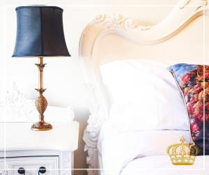 法灵登The Old Crown Coaching Inn的床头床边的床头柜上配有一盏灯的床铺,配有枕头