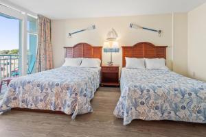 默特尔比奇2501 S Ocean Blvd, 0211 - Ocean Front Sleeps 8的一间带两张床的卧室和一个阳台