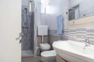 DeliaSicano Home的浴室配有白色卫生间和盥洗盆。