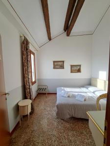 威尼斯洛坎达卡弗摩萨酒店的一间白色客房内带两张床的卧室