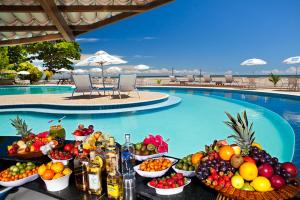 莫罗圣保罗Hotel Karapitangui的游泳池畔的水果和饮料自助餐