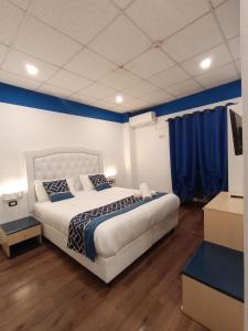 热那亚韦罗内塞酒店的一间卧室配有一张带蓝色墙壁的大床