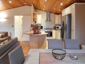 巴洛赫Kingfisher Lodge - Uk46046的厨房以及带沙发和桌子的客厅。