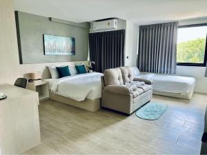 Aston Residence Hatyai的配有一张床和一把椅子的酒店客房