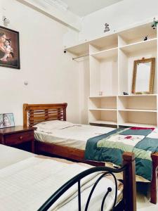 普塔帕蒂Shanthi Home Stay的一间卧室配有两张床和镜子