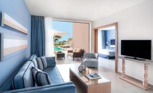 基拉奇尼奥利维亚酒店的客厅配有蓝色的沙发和电视