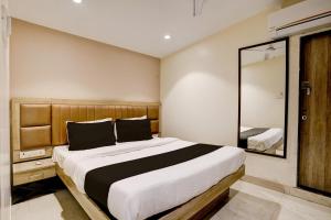 孟买Hotel Al Ibrahim的一间卧室配有一张大床和镜子