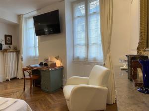 瓦朗斯Chambre de charme au coeur du vieux Valence - Confort & Calme的一间卧室配有桌子、椅子和电视