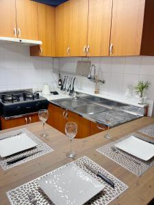 首尔Newly renovated spacious 2 bedroom unit in HBC的厨房配有水槽和2个酒杯,位于柜台上