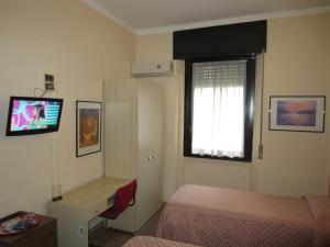 塞斯托-圣乔凡尼欧洲酒店的卧室配有一张床,墙上配有电视。
