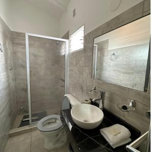 维拉卡洛斯帕兹Hotel Bellavista的浴室配有卫生间、盥洗盆和淋浴。