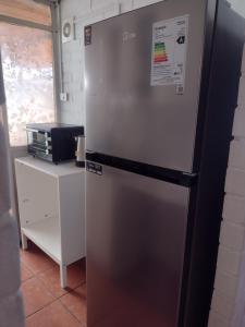 库里科Casa Foresta Curicó的冰箱冰柜,位于厨房的柜台旁