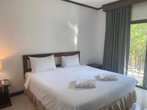 乌隆他尼President Hotel Udonthani的一间卧室配有一张大床和两条毛巾