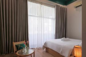 顺化Lemi - Homestay in Hue的酒店客房设有床和窗户。